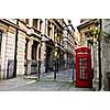 Red telephone box near old buildings in London