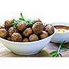 Fresh hot meatball appetizers served in white bowl with dipping sauce