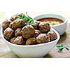 Fresh hot meatball appetizers served in white bowl with dipping sauce