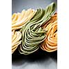 Assorted bundles of colorful raw tagliolini pasta noodles