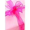 Gift box wrapped in pink paper with ribbon and bow