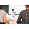 Senior chemistry professor giving a lecture in front of classroom full of students (shallow DOF; color toned image)