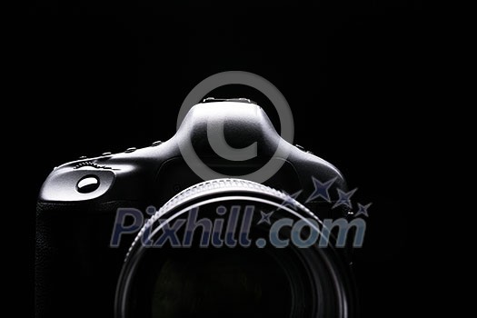 Professional modern DSLR camera low key image - Modern DSLR camera with a very wide aperture lens on Professional modern DSLR camera low key image - Modern DSLR camera with a very wide aperture lens on