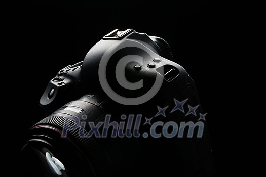Professional modern DSLR camera low key image - Modern DSLR camera with a very wide aperture lens on Professional modern DSLR camera low key image - Modern DSLR camera with a very wide aperture lens on