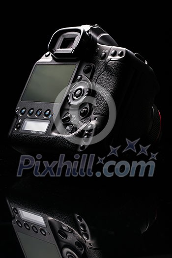 Professional modern DSLR camera low key image - Modern DSLR camera with a very wide aperture lens on Professional modern DSLR camera low key image - Modern DSLR camera with a very wide aperture lens on