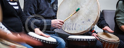 Group of people playing on drums - therapy by music