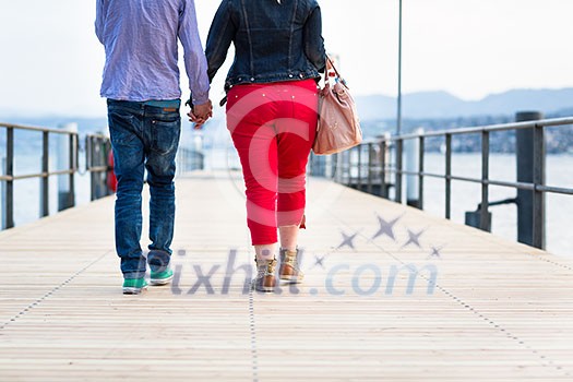 Opposites Attract - Quite disproportionate young couple walking on a jetty Opposites Attract - Quite disproportionate young couple walking on a jetty