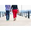 Opposites Attract - Quite disproportionate young couple walking on a jetty