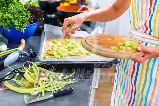 Young woman cooking in her modern kitchen (shallow DOF; color toned image) Young woman cooking in her modern kitchen (shallow DOF; color toned image)