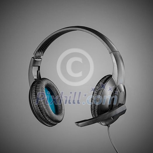 Headphones with microphone on grey background Headphones with microphone on grey background