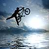silhouette of boy with bicycle jumping in air
