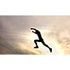 silhouette of jumping boy against sky. Header for website