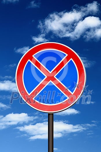 road sign no parking against blue sky and clouds