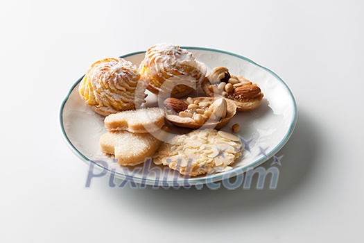 coockies with almond on plate isolated on white