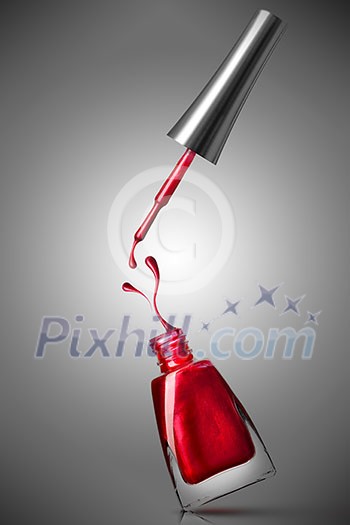 red nail polish bottle with splash