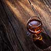 Cognac in glass on the wooden surface