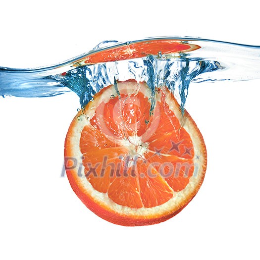 Fresh grapefruit dropped into water with splash isolated on white