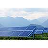solar panels on summer landscape with mountains on background
