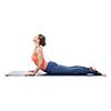 Beautiful sporty fit yogini woman practices yoga asana bhujangasana - cobra pose isolated on white background