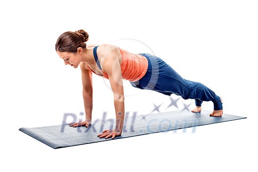 Young fit sporty woman doing Hatha yoga asana Utthita chaturanga dandasana - extended four-limbed staff (plank) pose isolated Young fit sporty woman doing Hatha yoga asana Utthita chaturanga dandasana - extended four-limbed staff (plank) pose isolated