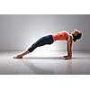 Beautiful sporty fit yogini woman practices Ashtanga Vinyasa yoga asana Purvottanasana - upward-facing plank full pose