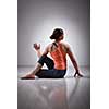 Beautiful sporty fit yogini woman practices yoga asana ardha matsyendrasana - half spinal twist pose
