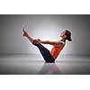 Beautiful sporty fit yogini woman practices yoga asana Paripurna navasana - boat pose