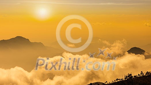 Panorama of mountains in clouds on sunset Panorama of mountains in clouds on sunset