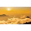 Panorama of mountains in clouds on sunset