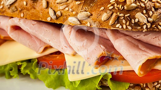 Panorama of ham sandwich with lettuce, cheese, tomato close up