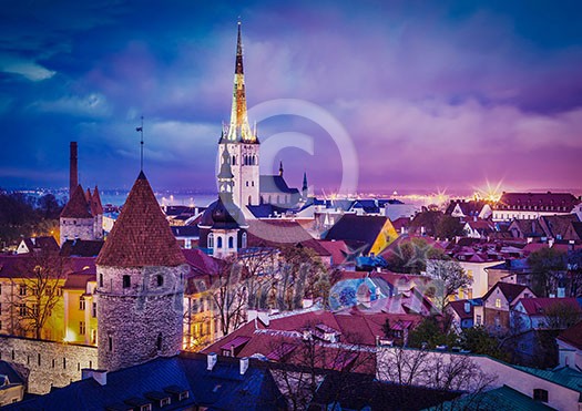 Vintage retro effect filtered hipster style image of Tallinn Medieval Old Town illuminated in evening twilight, with dramatic sky Estonia