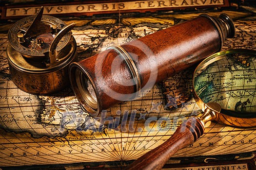Travel geography navigation concept background - old vintage retro compass with sundial, spyglass and magnifying glass on ancient world map