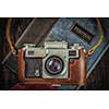 Photography concept  background - old retro vintage camera on photo album on grunge wooden texture