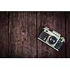 Photography concept  background - old retro vintage camera on grunge wooden texture