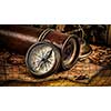Travel geography navigation concept background - panorama of old vintage retro compass with sundial, spyglass and rope on ancient world map