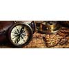 Travel geography navigation concept background - letterbox panorama of old vintage retro compass with sundial, spyglass and rope on ancient world map