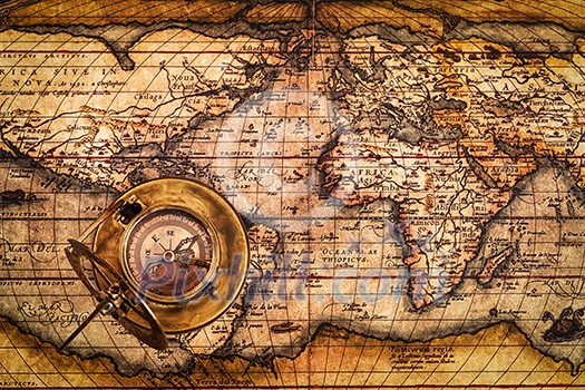 Travel geography navigation concept background - old vintage retro compass with sundial on ancient world map