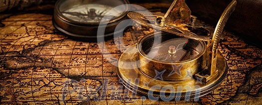 Travel geography navigation concept background - letterbox panorama of old vintage retro compass with sundial and spyglass on ancient world map with copyspace