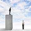 Conceptual image of businessman standing on bar and looking down at woman