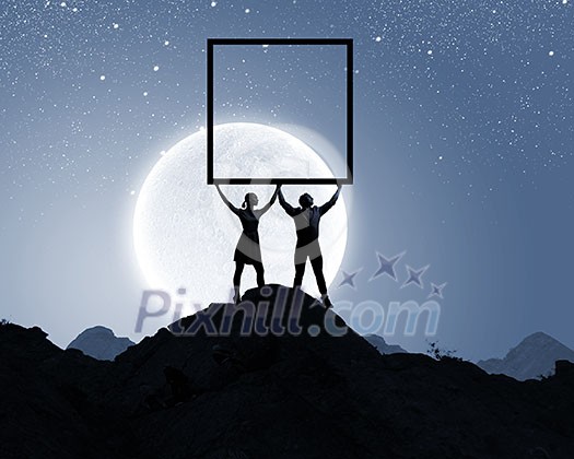 Silhouettes of young couple against full moon Silhouettes of young couple against full moon