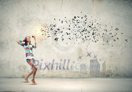 Young woman in colored dress speaking in megaphone Young woman in colored dress speaking in megaphone