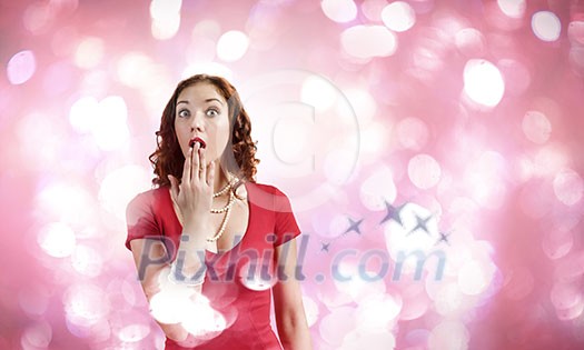 Young pretty girl in red dress against bokeh background Young pretty girl in red dress against bokeh background
