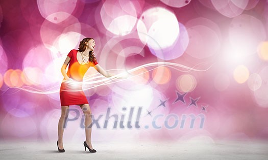 Young woman in red dress playing guitar