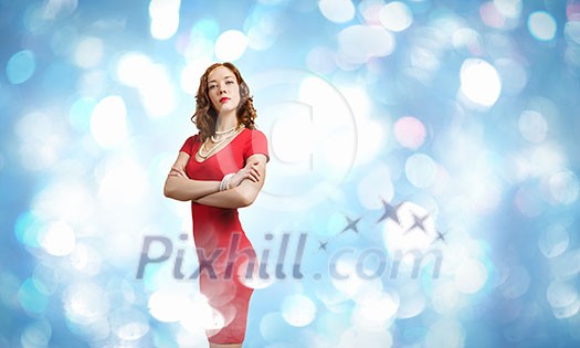 Young woman in red dress against bokeh background