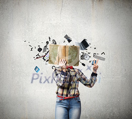 Woman in casual wear hiding her face behind book