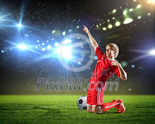 Football player standing on knees and screaming with joy