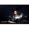 Little Halloween witch reading conjure above pot