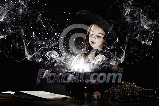 Little Halloween witch reading conjure above pot