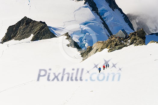 Group of people walking among snows of New Zealand mountains Group of people walking among snows of New Zealand mountains