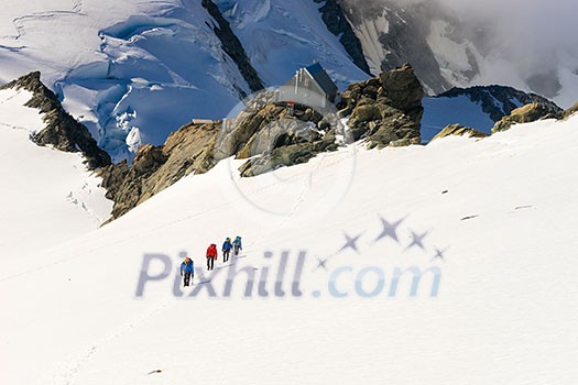 Group of people walking among snows of New Zealand mountains Group of people walking among snows of New Zealand mountains
